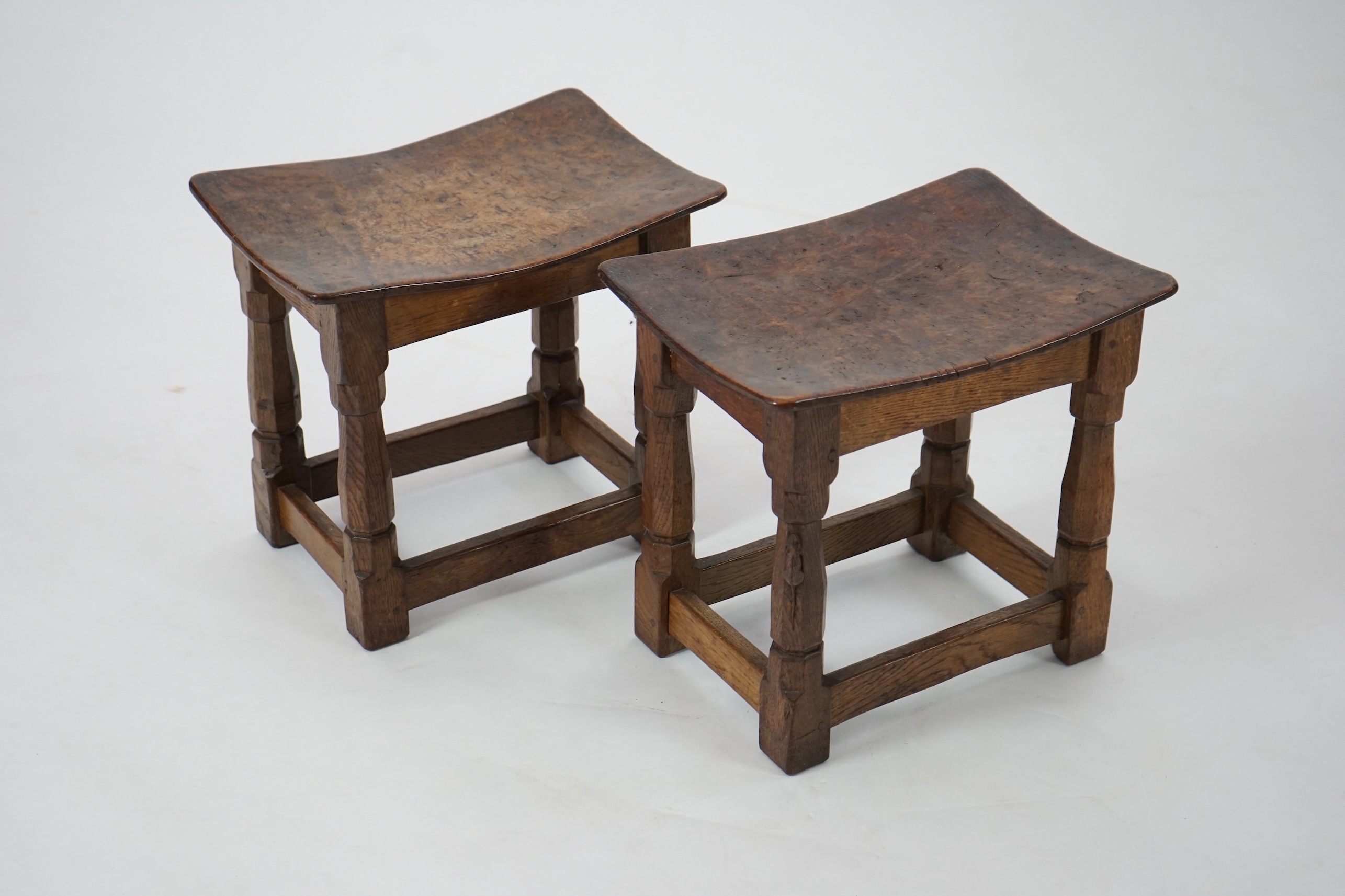 A pair of Robert 'Mouseman' Thompson burr oak stools, 1930s